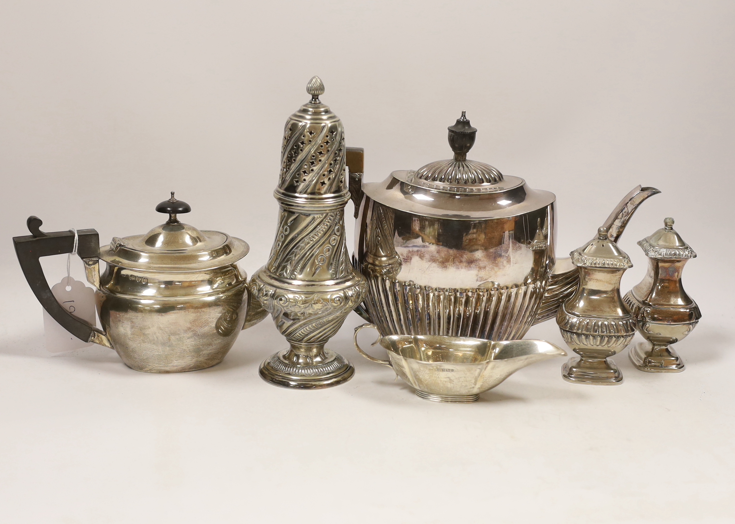 A late Victorian silver bachelor's oval teapot, Florence Warden, Chester, 1897, together with a small Edwardian silver sauceboat and four items of plated ware including a sugar caster and teapot
